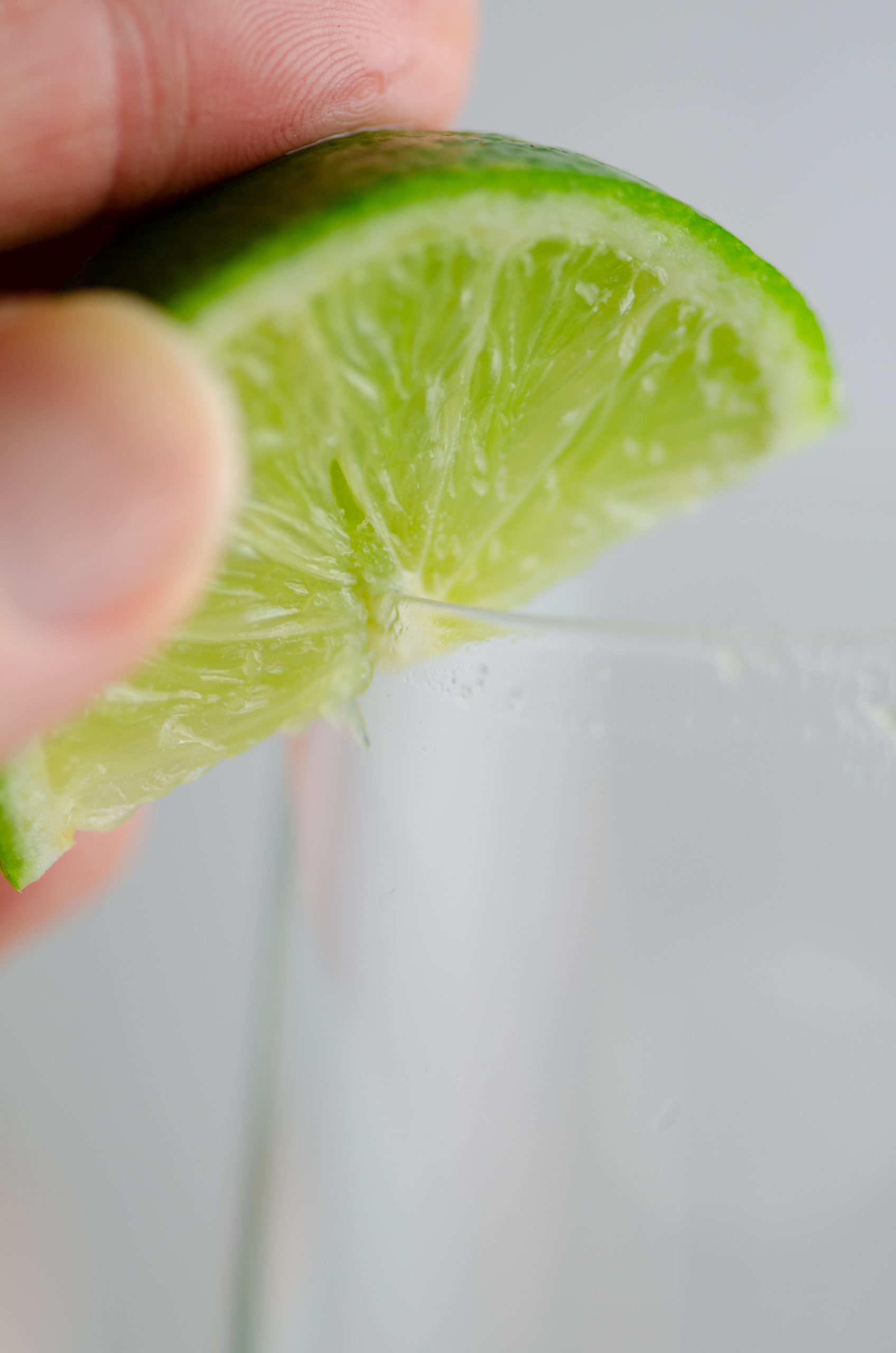 Lime on rim of champagne flute. 