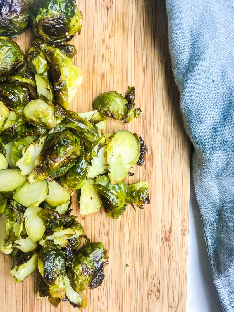 Chopped roasted brussels sprouts on a cutting board. 