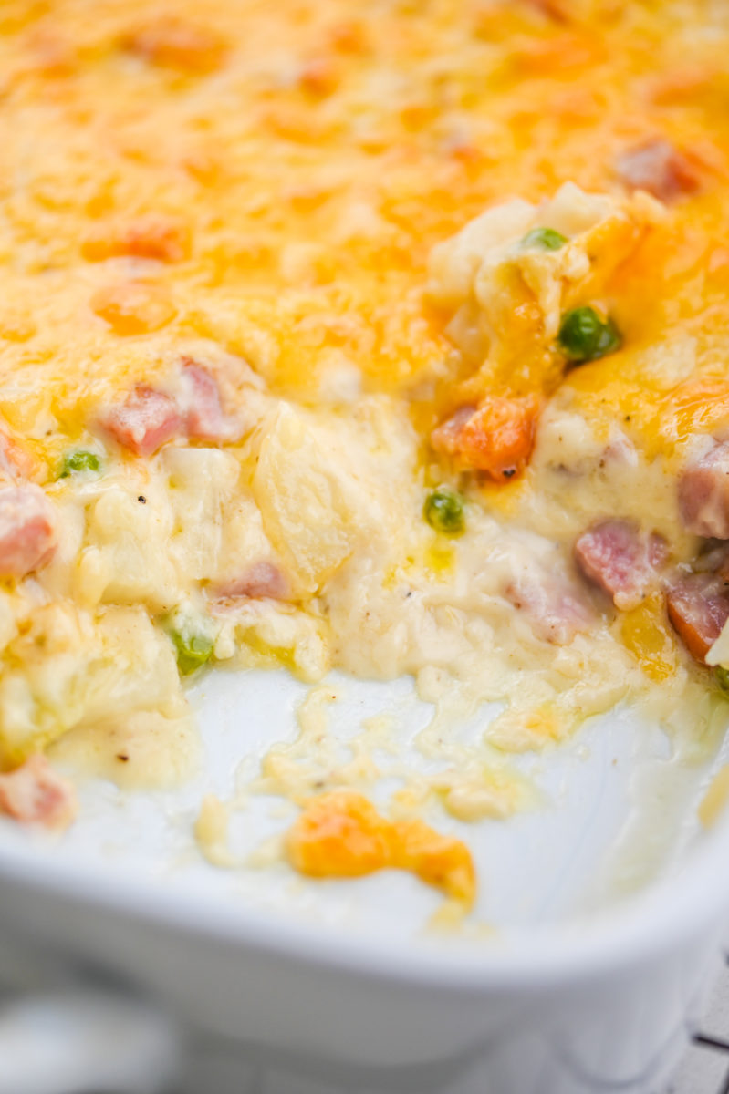 Ham potato casserole in white casserole dish. 