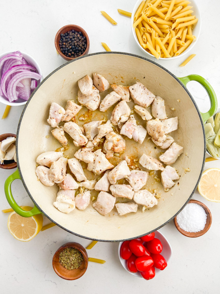 Cook diced chicken breast in pan. 