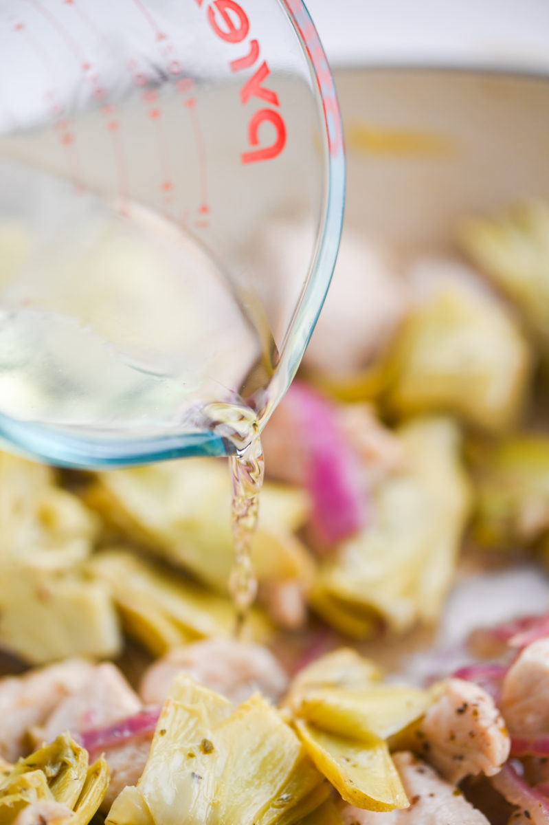 Deglazing the pan with white wine. 