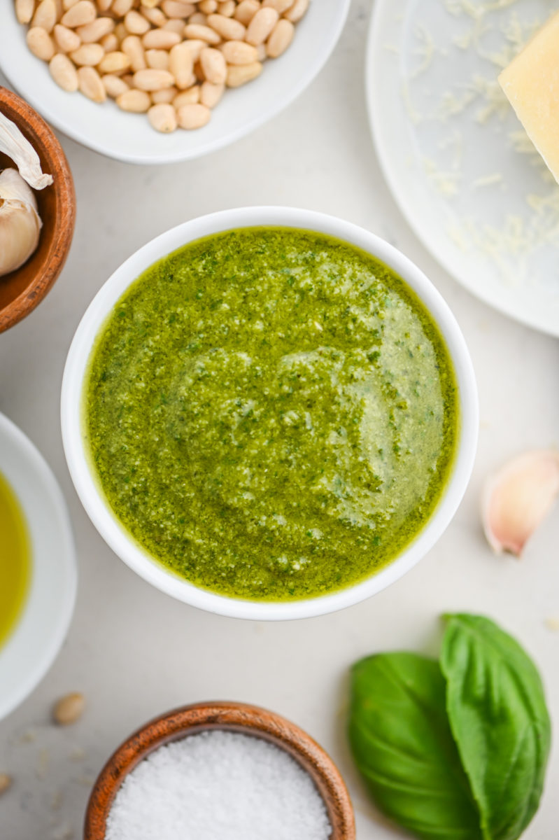 Overhead photo of basil pesto in a white bowl.