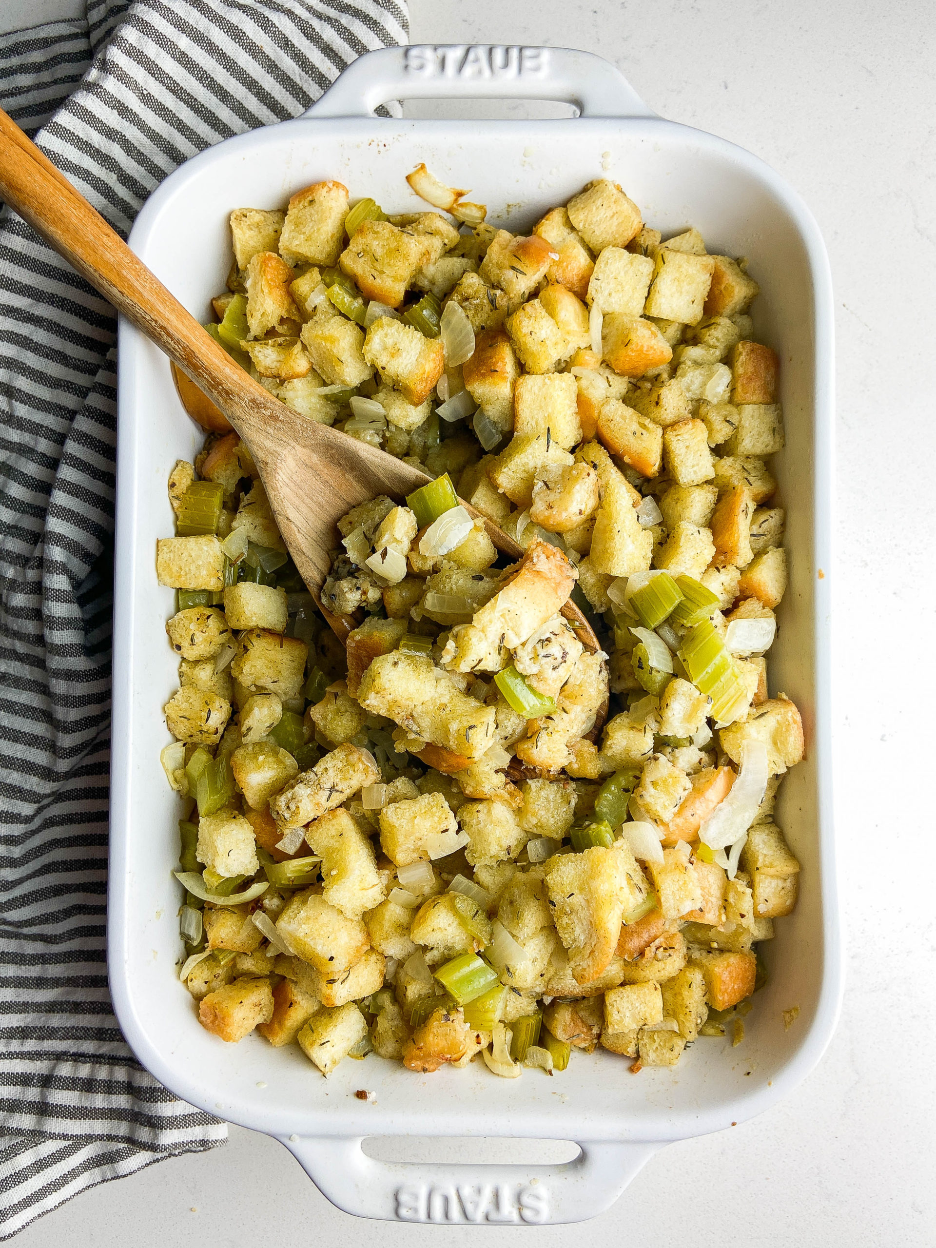 Overhead photo of stuffing a white dish. 