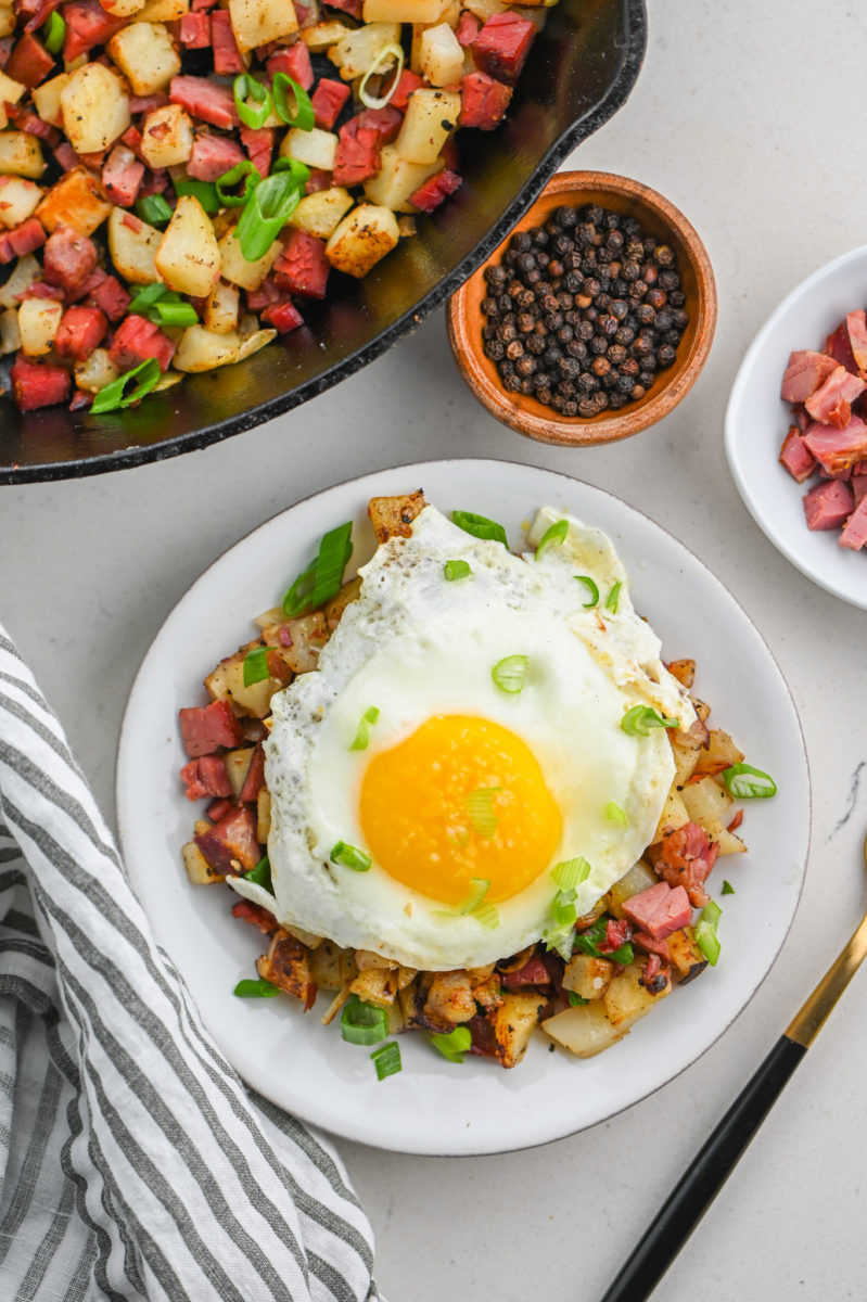 Overhead photo of corned beef hash topped with a fried egg. 