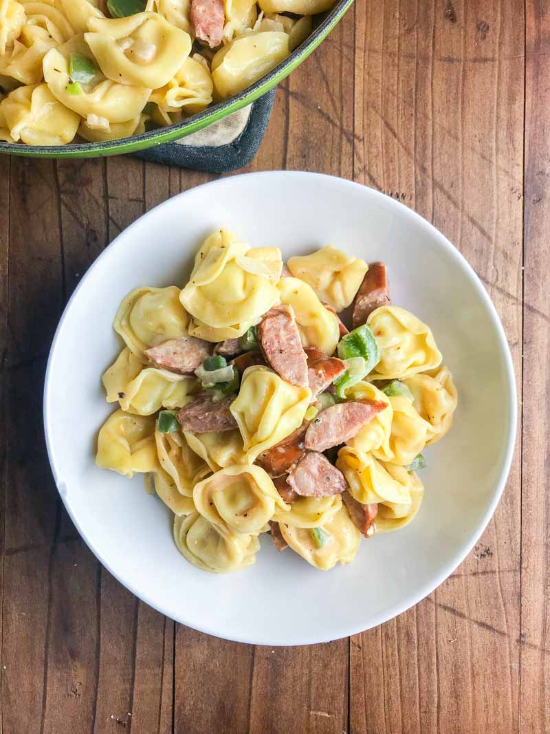 Creamy Cajun Tortellini is a decadent, spicy pasta dish that comes together in a flash. Cheesy tortellini, andouille sausage and bell peppers simmered in a creamy cajun sauce. 