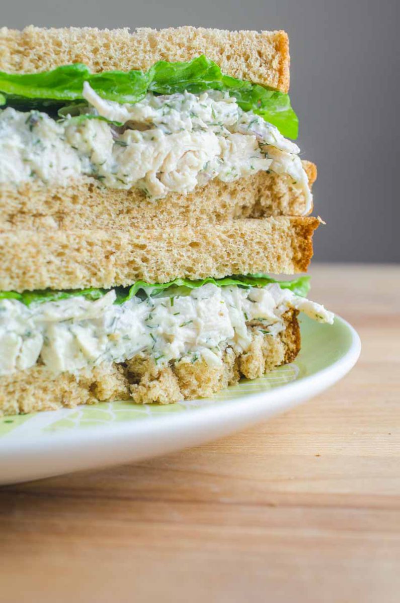 A creamy dill chicken salad sandwich made with fresh dill, mayo, yogurt, garlic, chicken and red onion. The perfect summer sandwich.