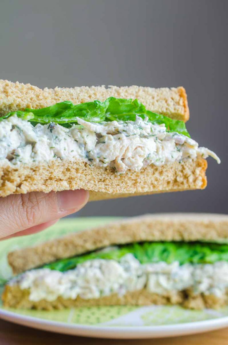 A creamy dill chicken salad sandwich made with fresh dill, mayo, yogurt, garlic, chicken and red onion. The perfect summer sandwich.