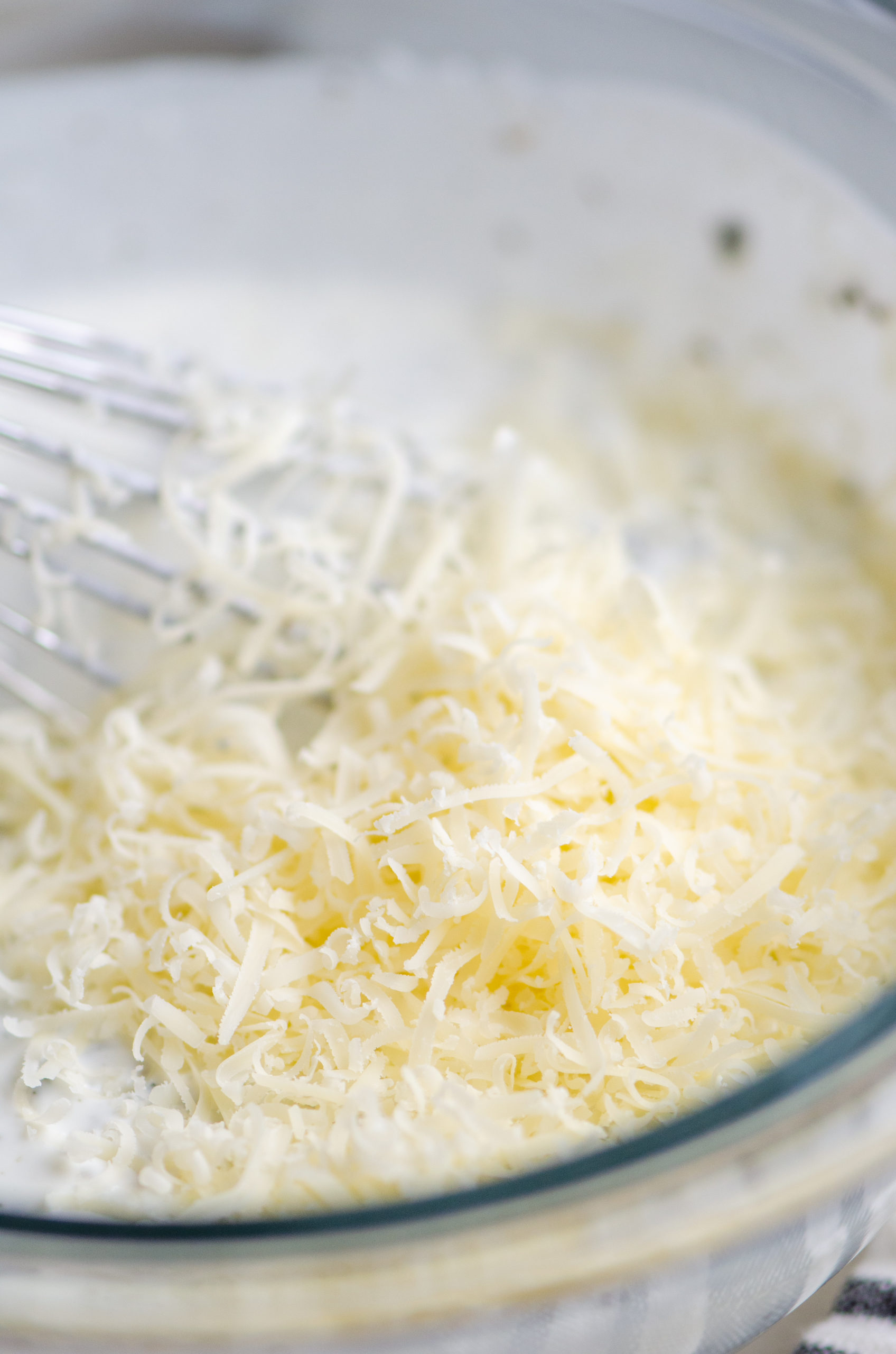 Close up photo of grated parmesan in dressing