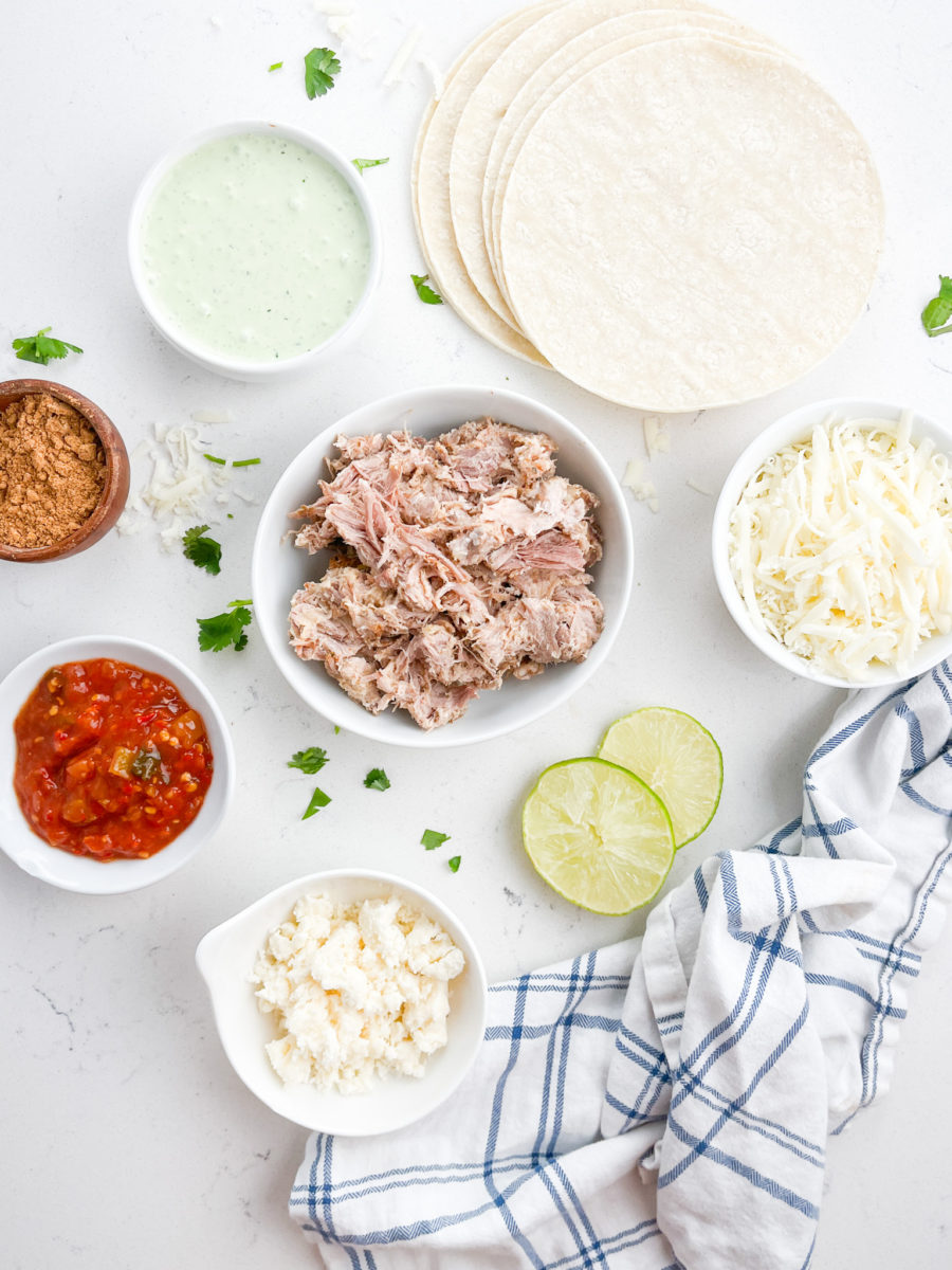 Crispy Pork Tacos ingredients on white background with towel. 