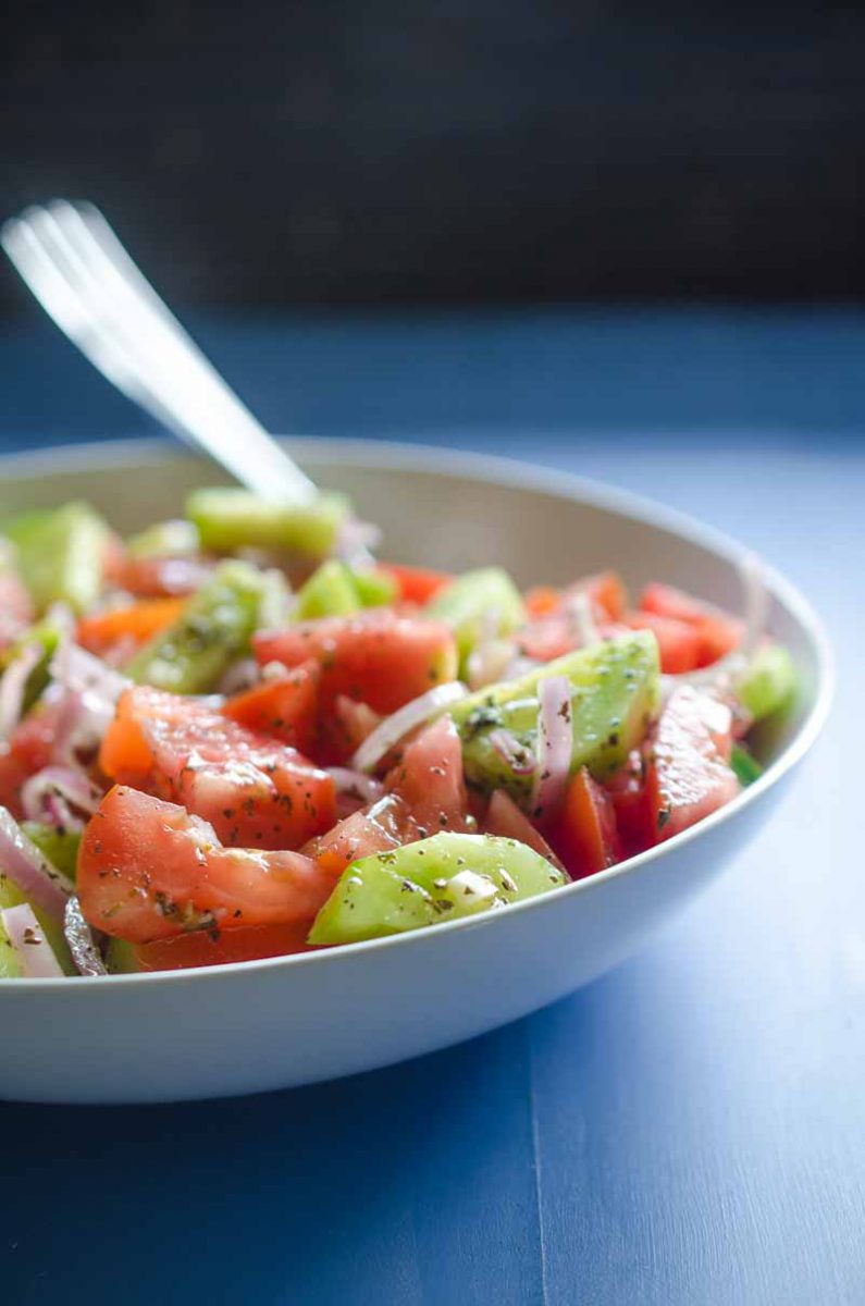 Cucumber Tomato Salad is my absolute favorite summer salad. Fresh cucumbers, summer tomatoes, shallots and a quick vinaigrette make this perfect for all of your summer cookouts. 