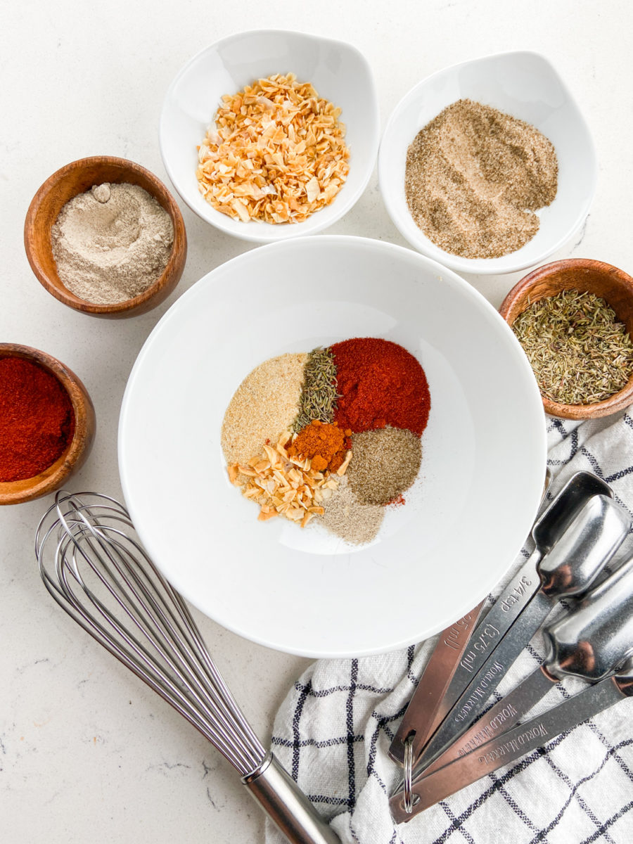 Cajun seasoning ingredients separated in white bowl. 