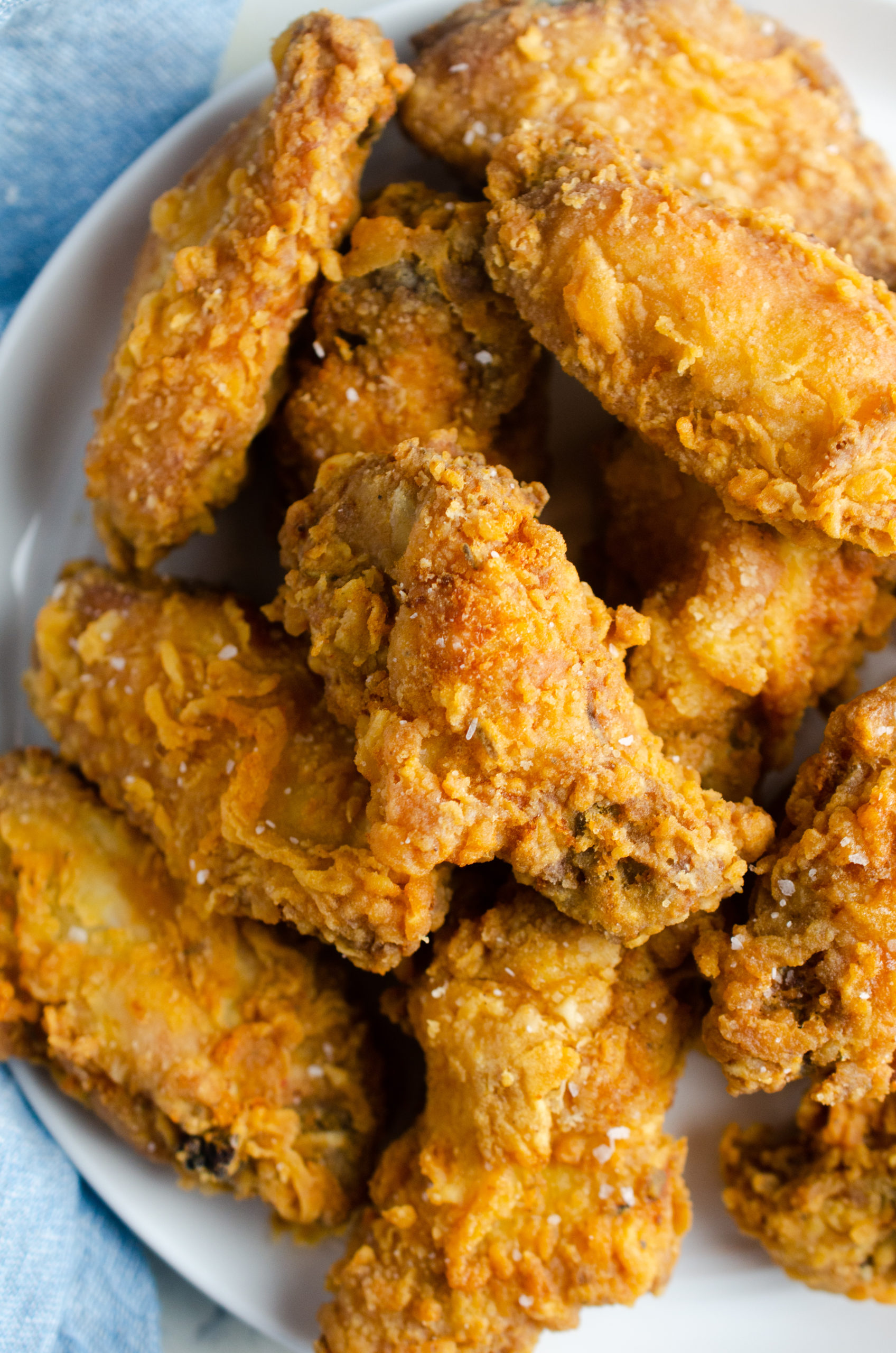 Plate of crispy fried chicken wings. 