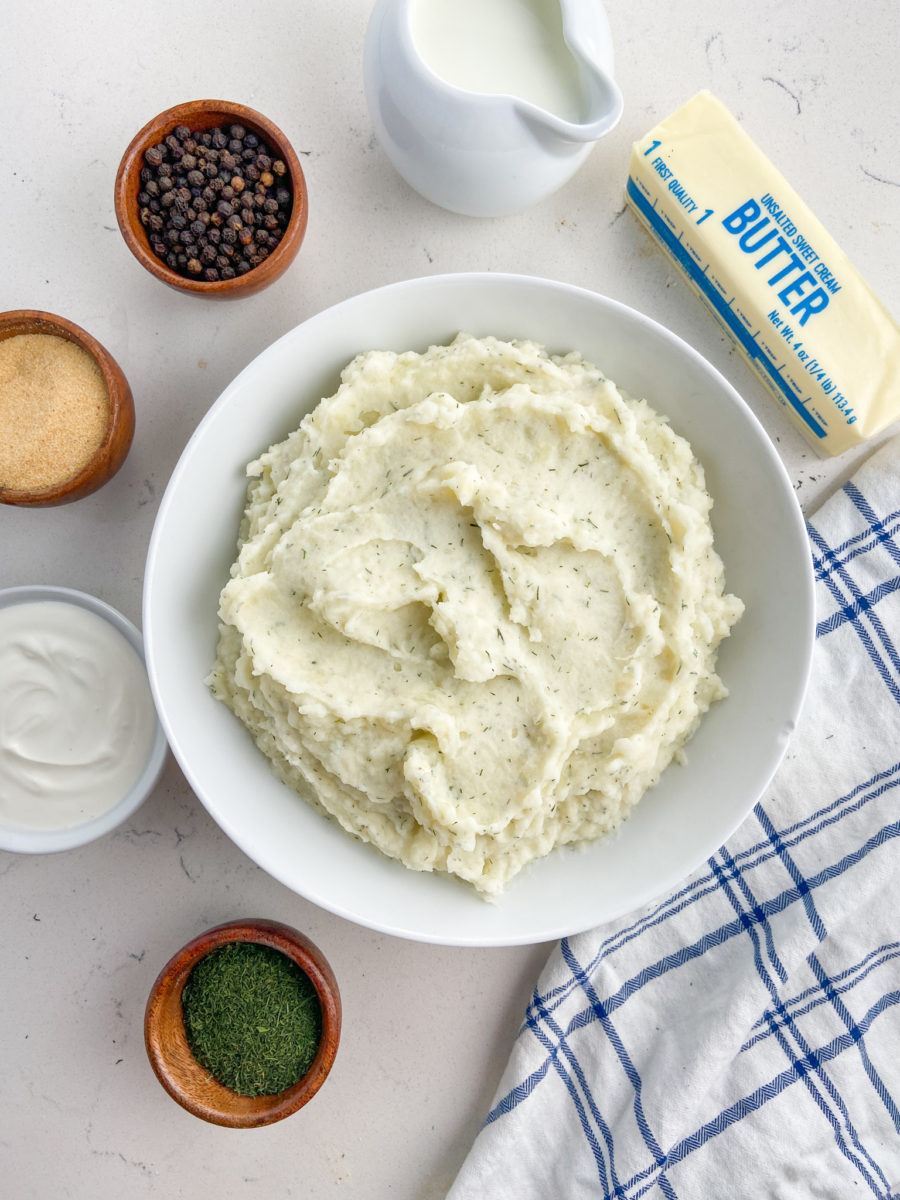 Dill mashed potatoes in a white bowl. 