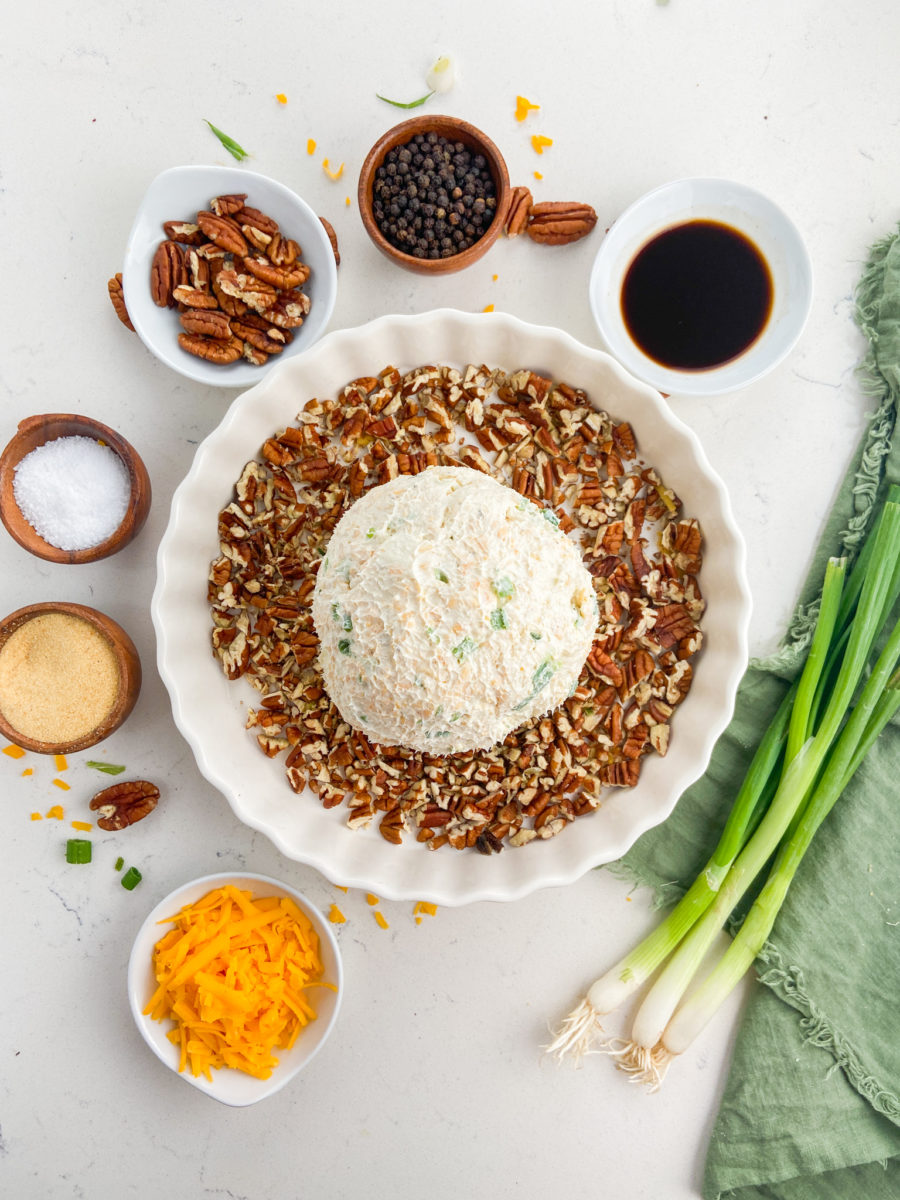 Rolling cheese ball in chopped pecans. 