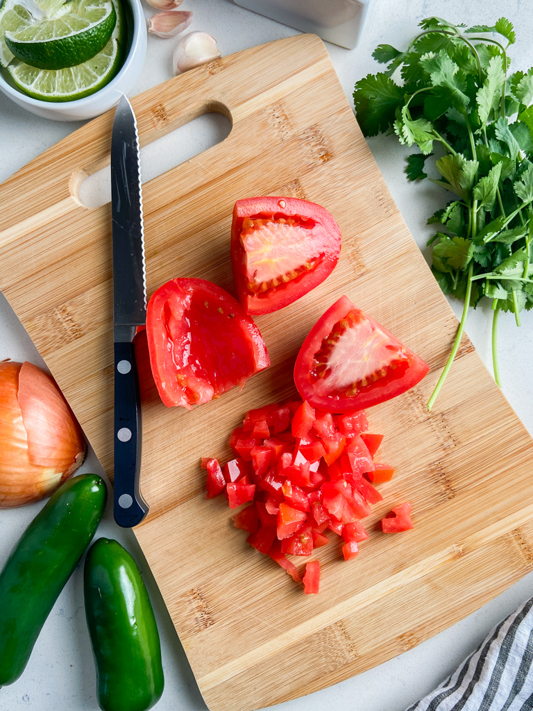 Overhead photo of ingredients needed to make pico de gallo. 