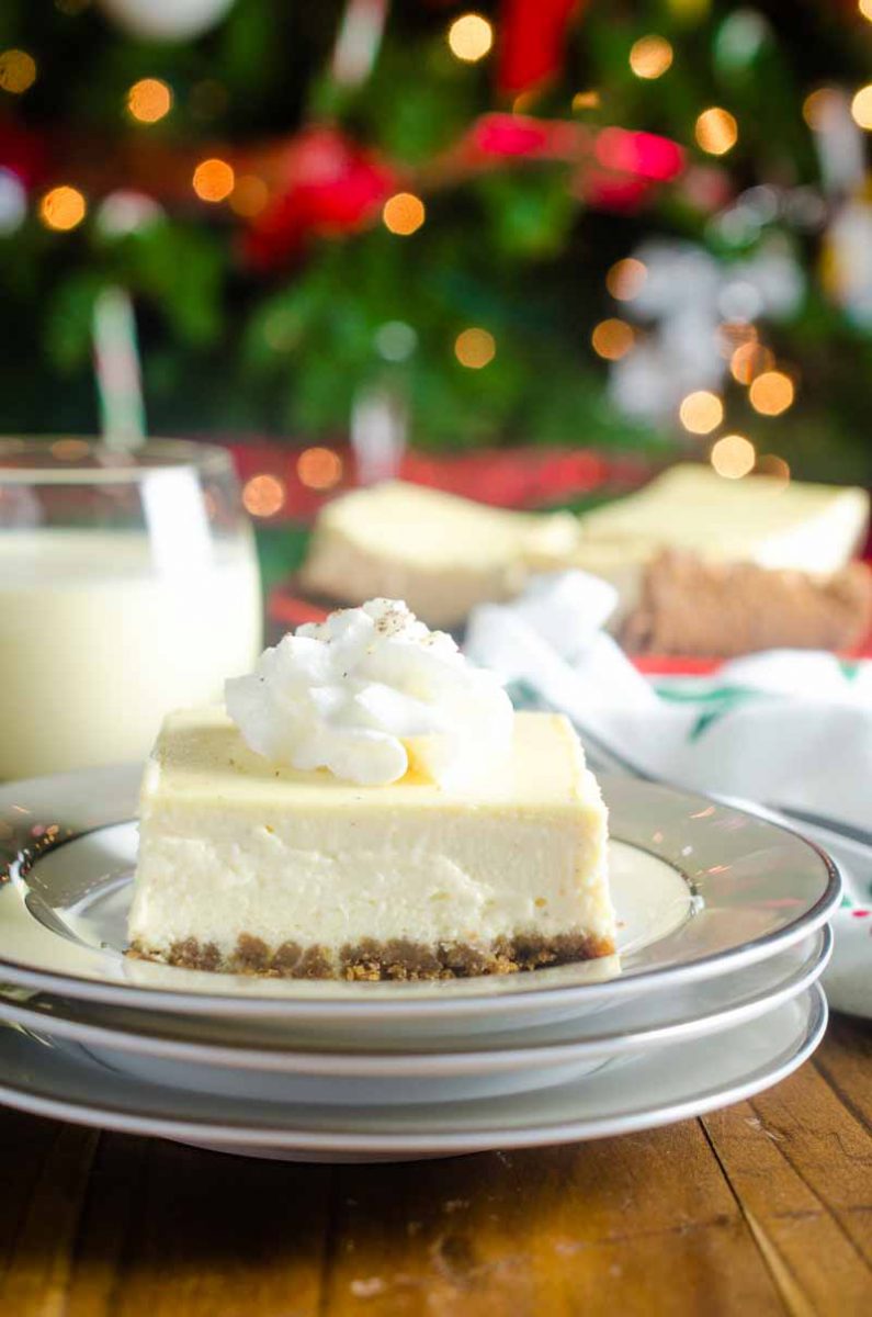 Eggnog Cheesecake Bars are the perfect dessert for holiday get togethers! Gingersnap crust and smooth eggnog cheesecake make them irresistible. 