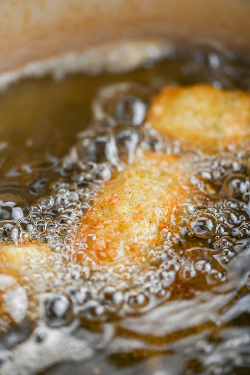 Artichoke hearts frying in oil. 