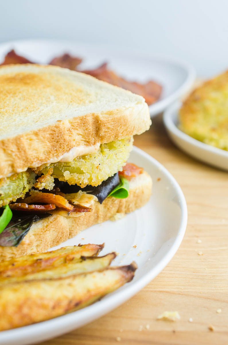 A fried green tomato BLT combines two classic foods into one comfort food sandwich. Fried green tomatoes and a bacon, lettuce and tomato sandwich become an epic Fried Green Tomato BLT. Topped with Cajun mayo spread, this will become your new favorite sandwich recipe! 