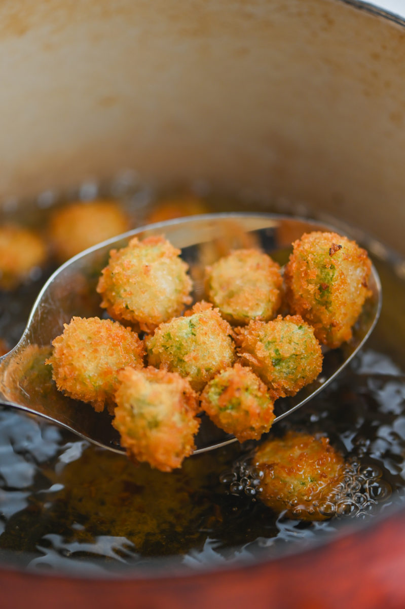 Okra in a slotted spoon. 