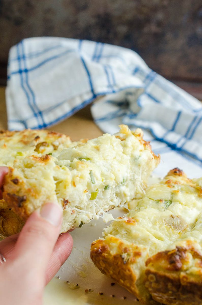 Garlic Cheese Bread with 3 cheeses and sweet roasted garlic. An easy, cheesy bread that is a perfect side dish or a meal in itself!