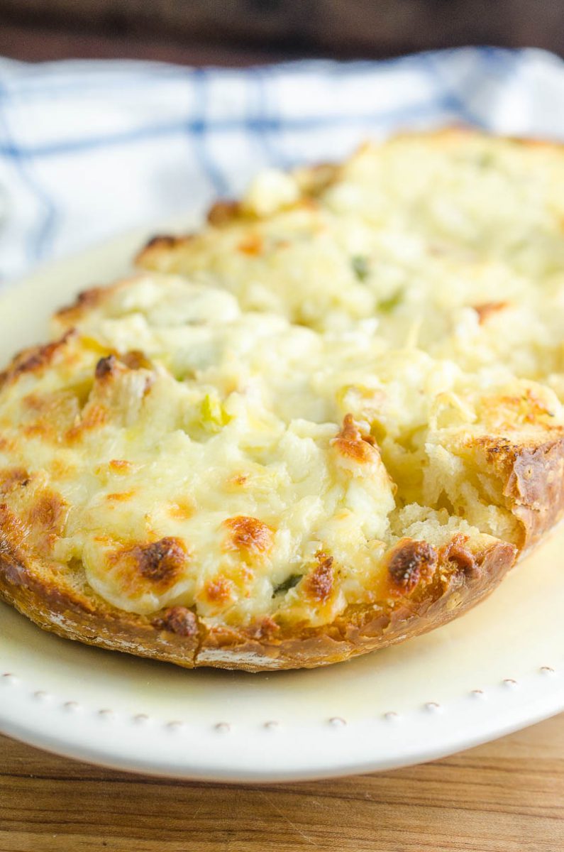 Garlic Cheese Bread with 3 cheeses and sweet roasted garlic. An easy, cheesy bread that is a perfect side dish or a meal in itself!