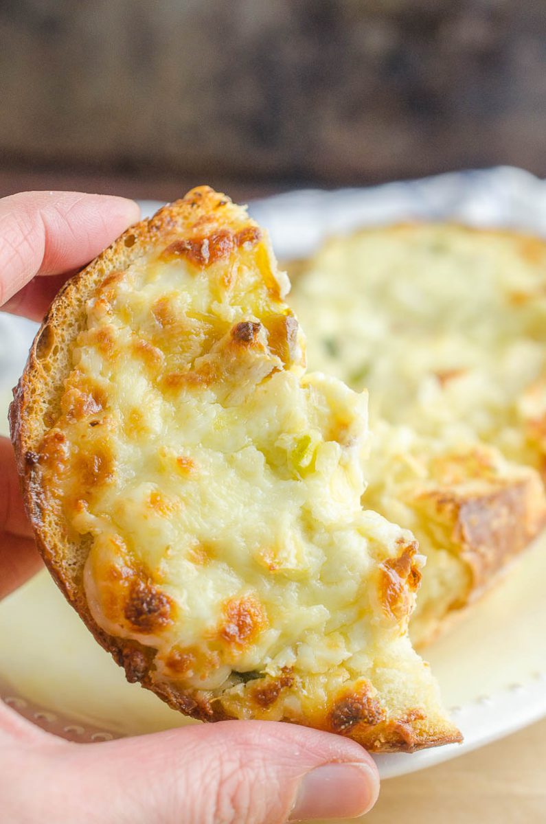 Garlic Cheese Bread with 3 cheeses and sweet roasted garlic. An easy, cheesy bread that is a perfect side dish or a meal in itself!