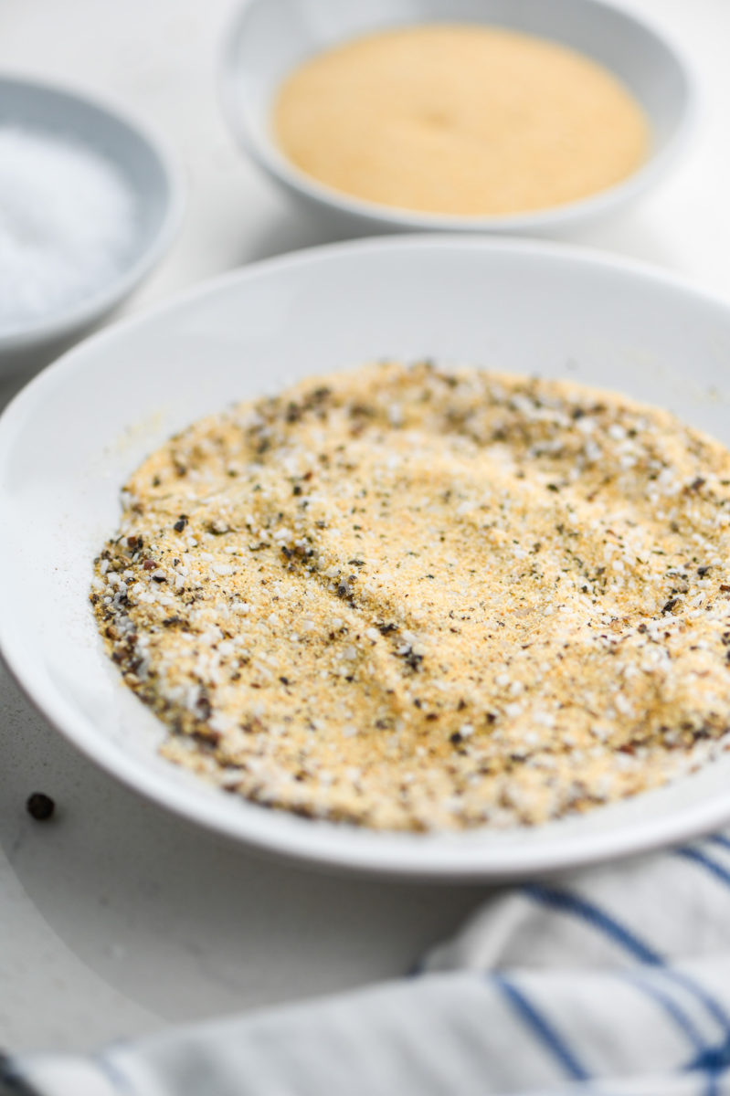 Garlic pepper seasoning on white plate. 