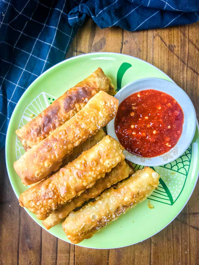 Crispy Ginger Chicken Egg Rolls are loaded with ground chicken, fresh ginger, mushrooms, green onions and cilantro. A classic Asian appetizer!