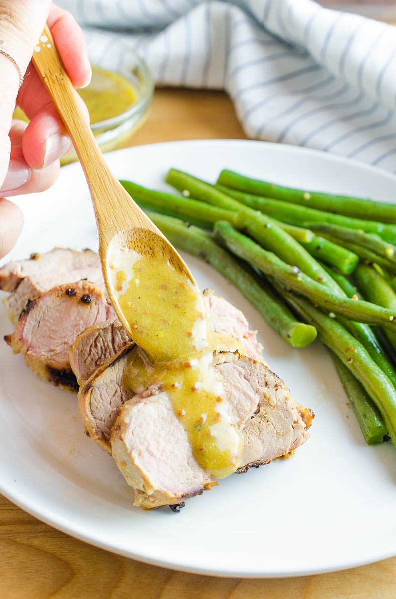 Drizzling honey mustard sauce over pork tenderloin. 