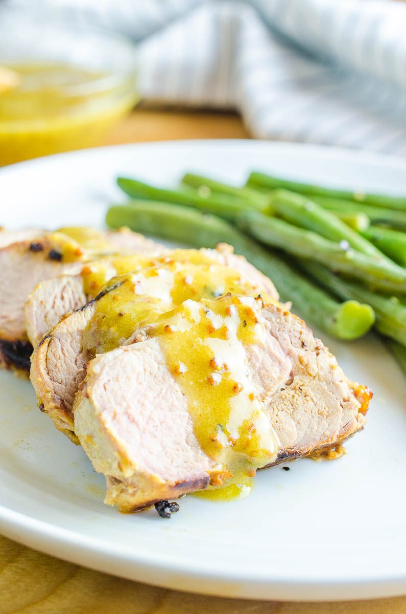 Grilled Pork Tenderloin is an easy flavorful dinner. Marinated in a honey mustard sauce and then grilled to perfection. An easy family dinner!  