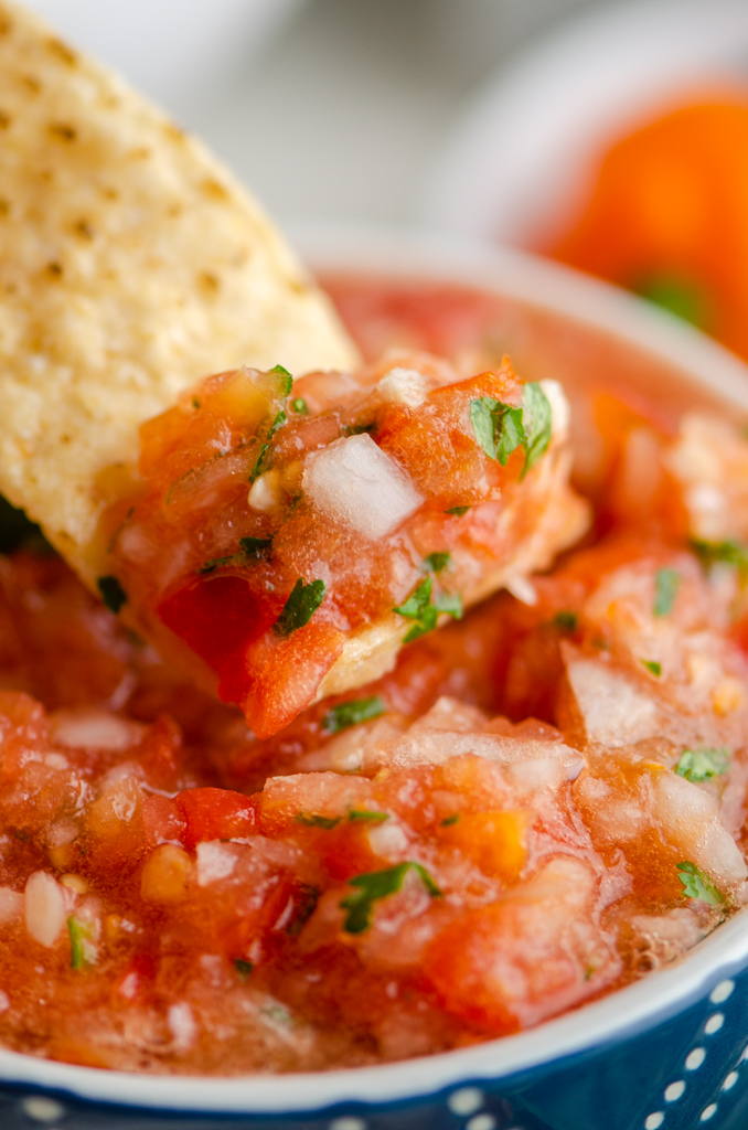 Close up of chip dipped in habanero salsa