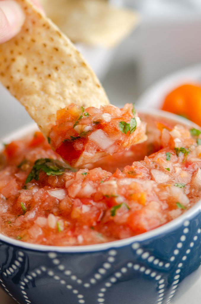 Chip dipping in habanero salsa. 