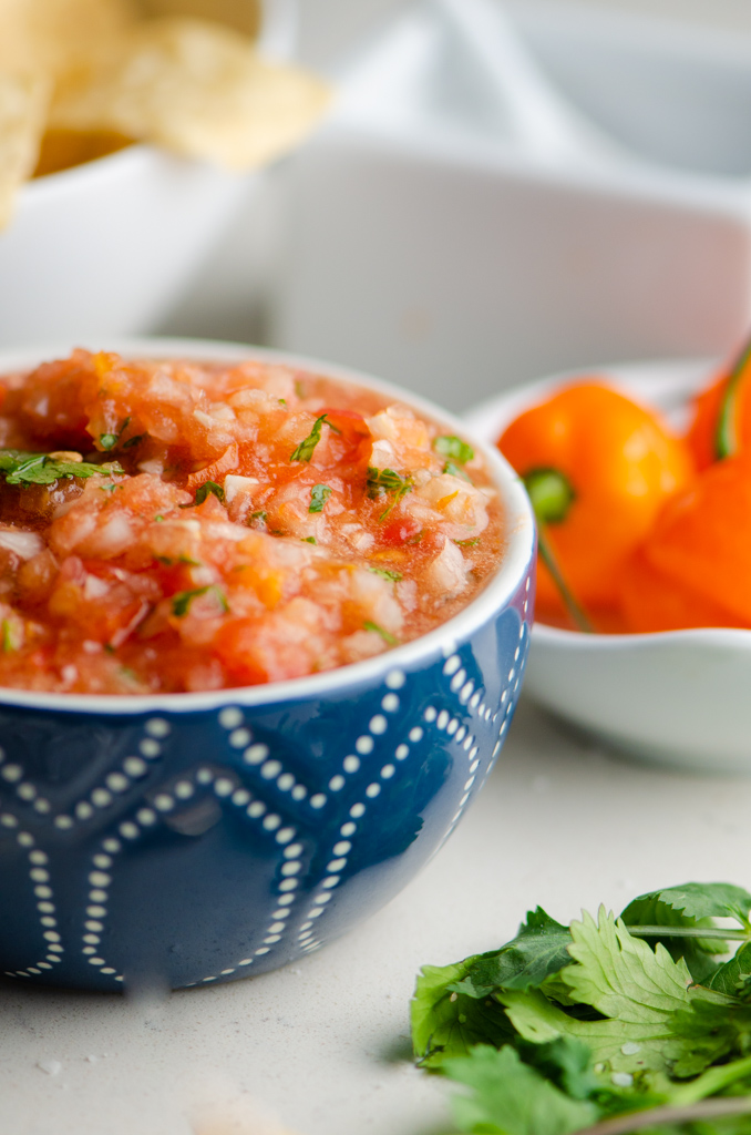 Side photo of habanero salsa in a blue bowl. 
