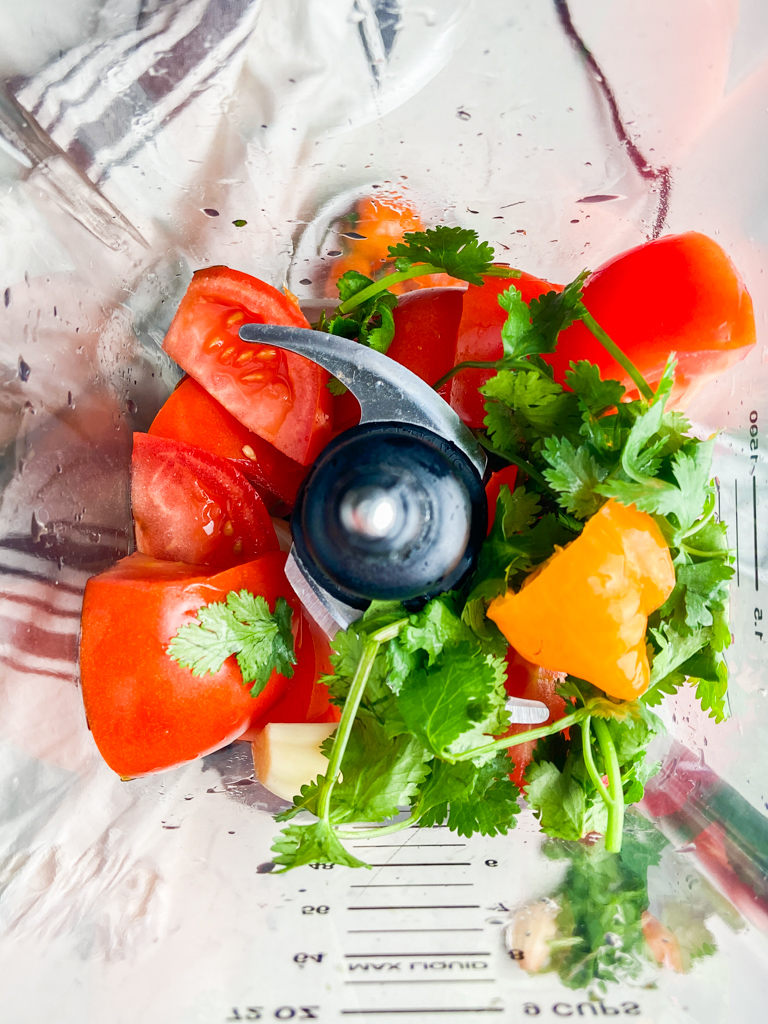 Overhead photo of habanero salsa ingredients inside blender. 