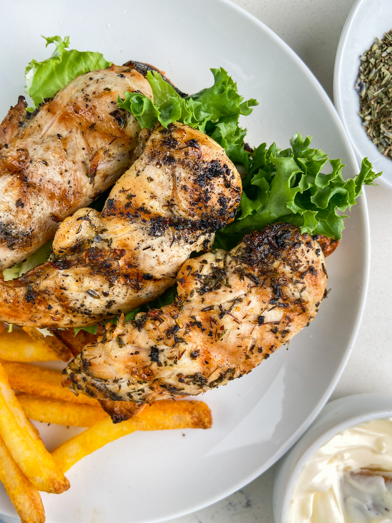 Overhead photo of chicken sandwich on a plate. 