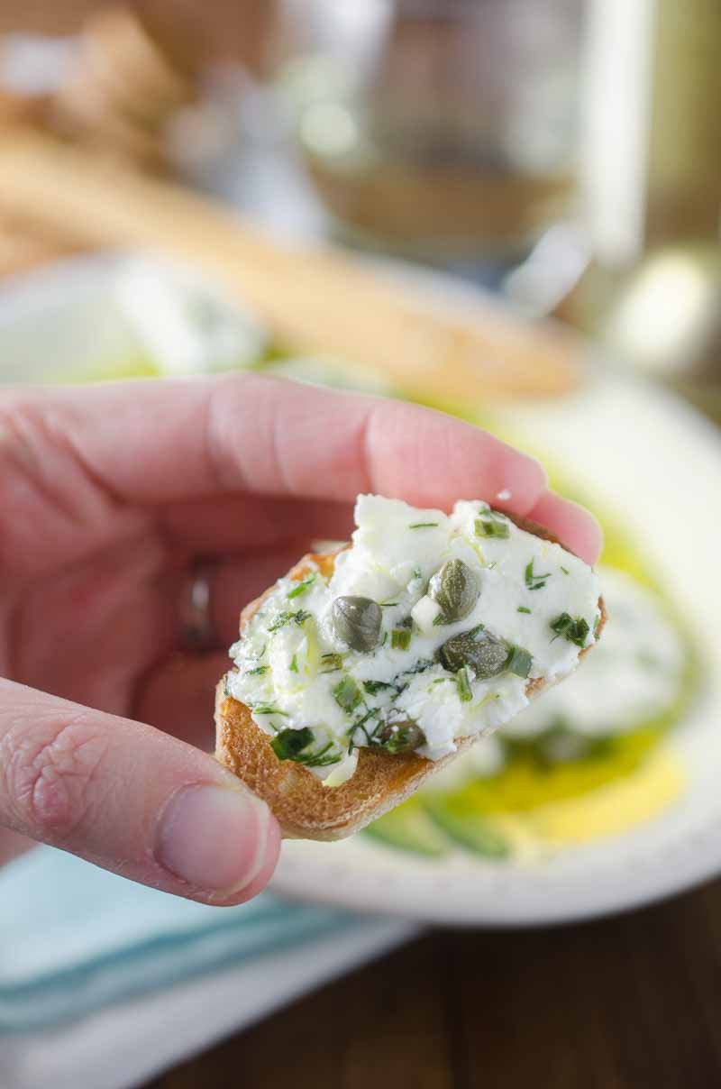 Tangy herb marinated goat cheese is the perfect appetizer to enjoy with a glass of wine. 