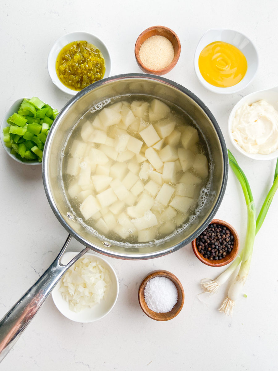 Diced potatoes in water in stainless steel pot