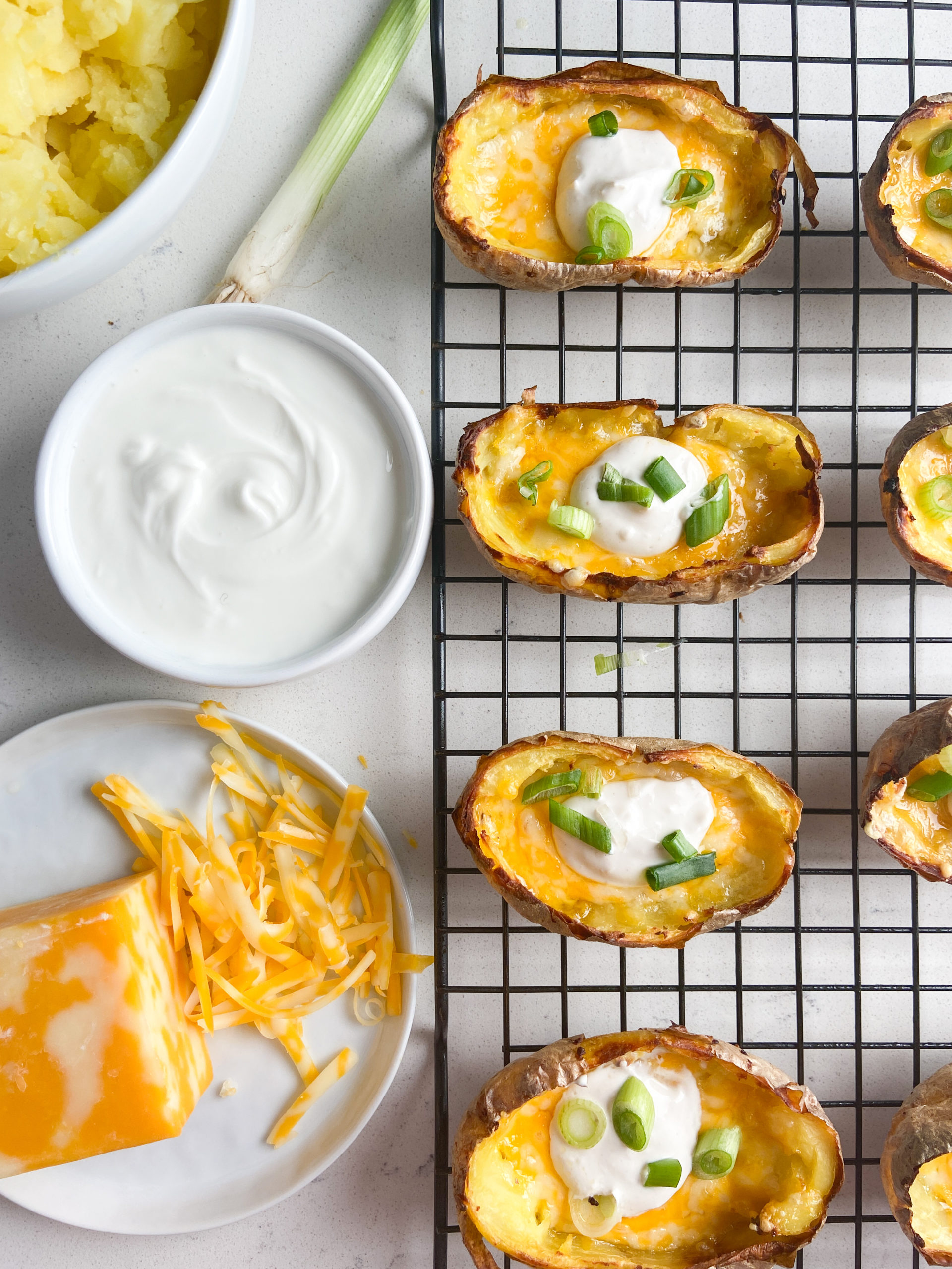 Overhead photo of potato skins on a cooling rack. 