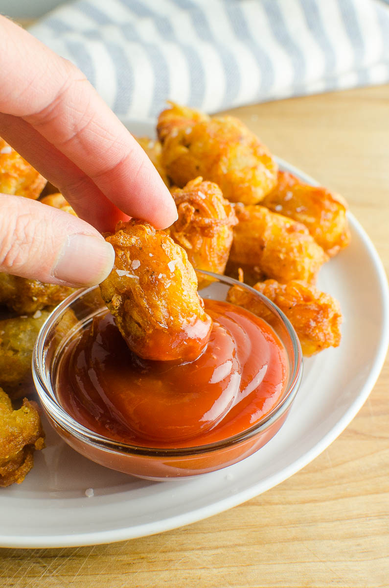 Dipping a tater tot in ketchup. 