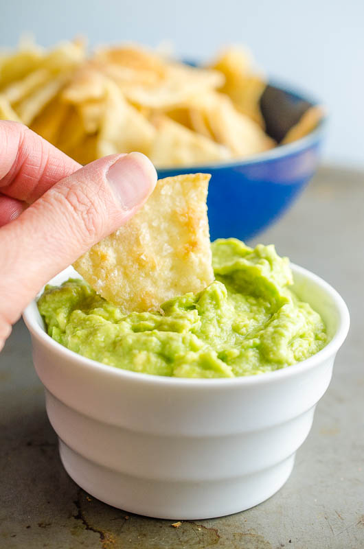 Dipping a chip in guacamole. 
