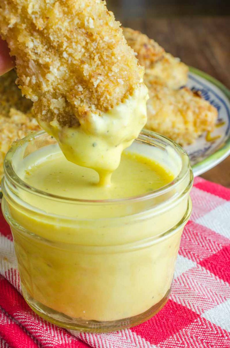 Baked Honey Mustard Chicken Tenders are marinated in honey mustard dressing, dredged in panko and baked until golden. They are a family favorite and perfect for weeknights!