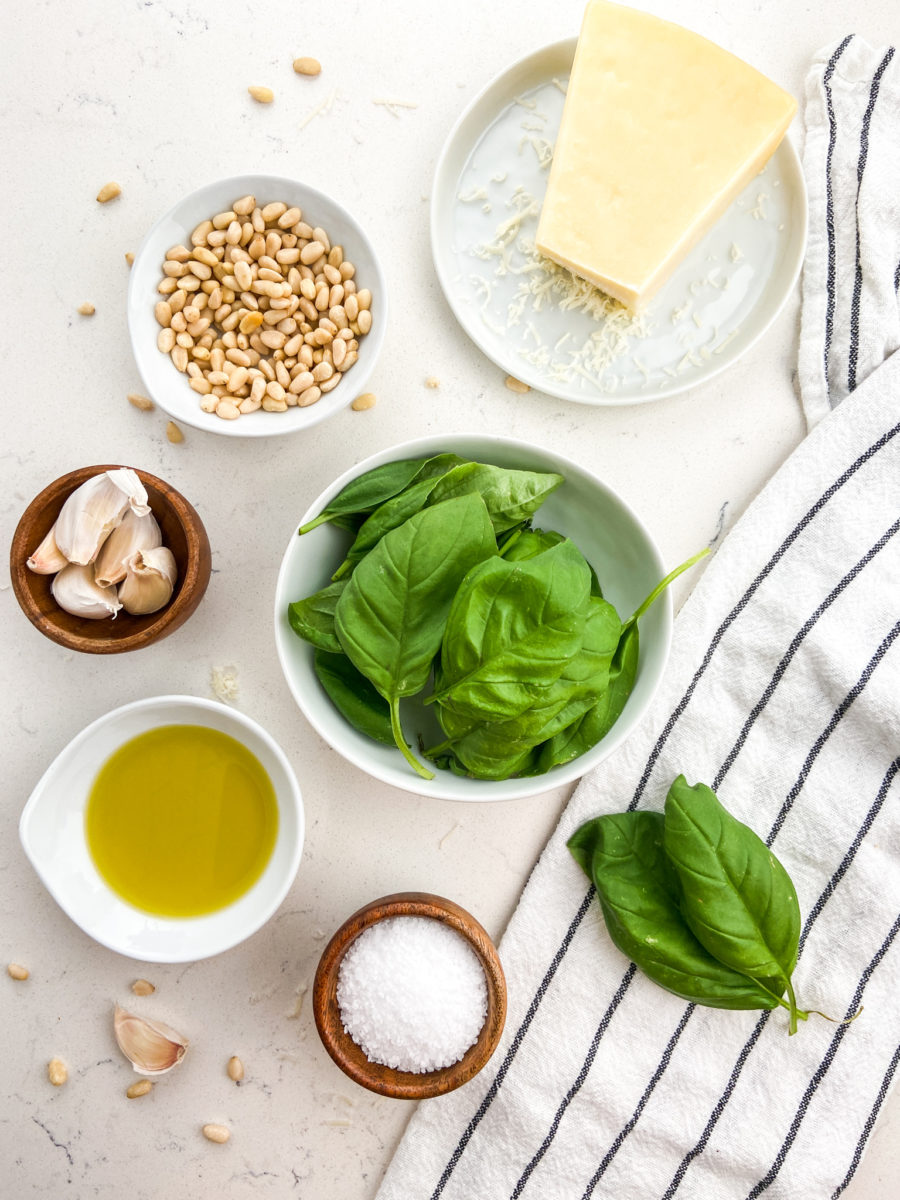 Overhead photo of ingredients for basil pesto. 