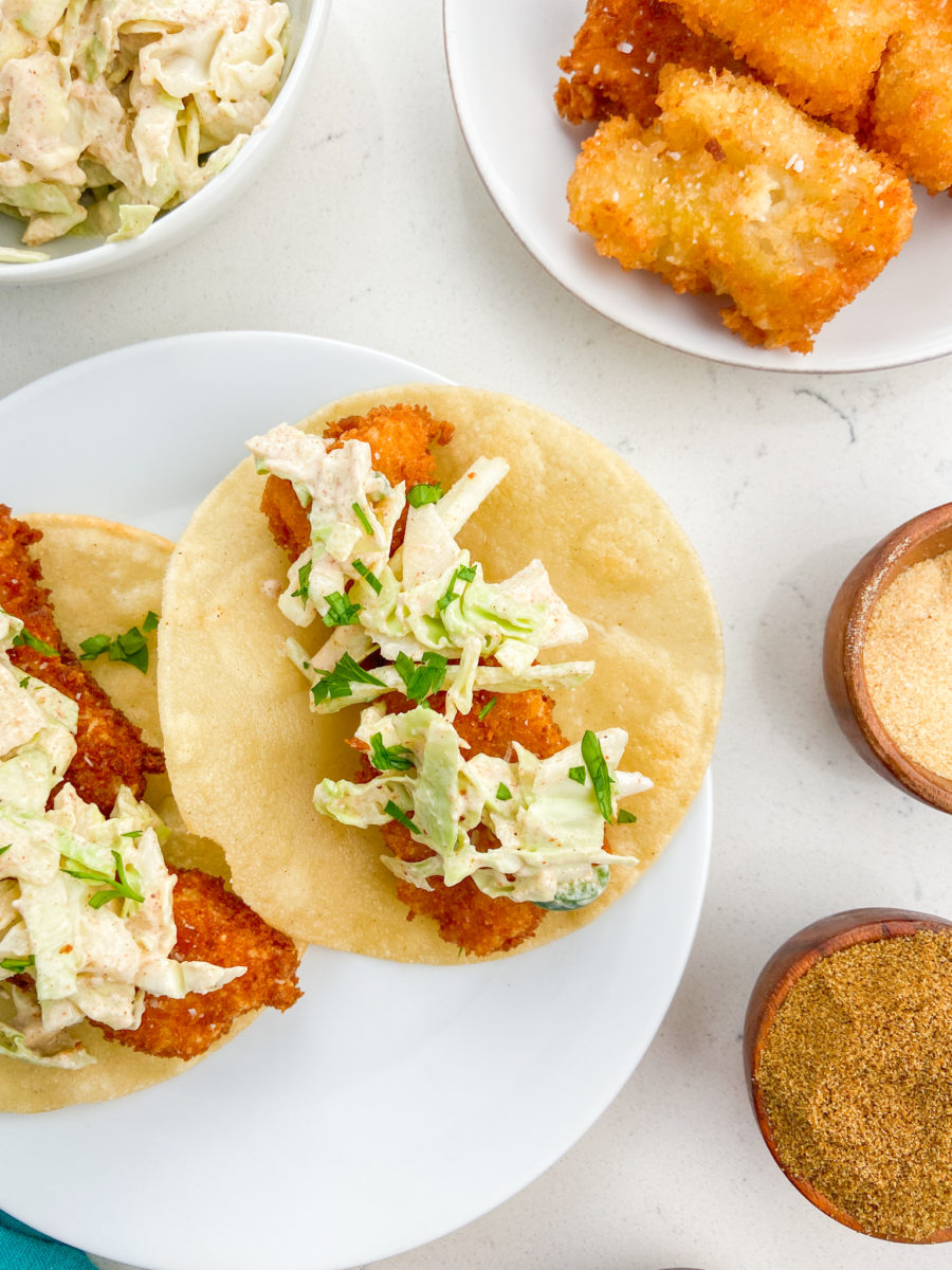 Fish taco on white plate. 