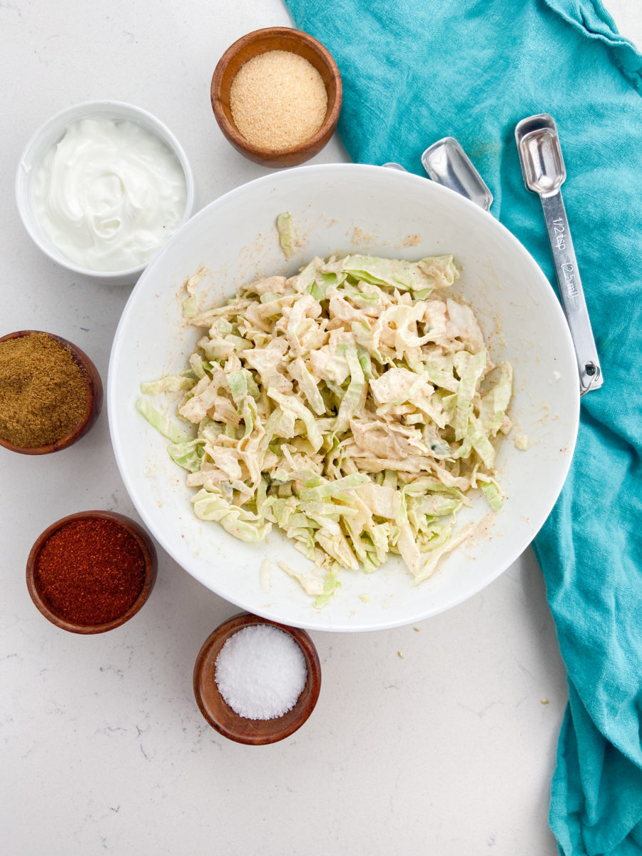 Coleslaw for fish tacos in white bowl. 