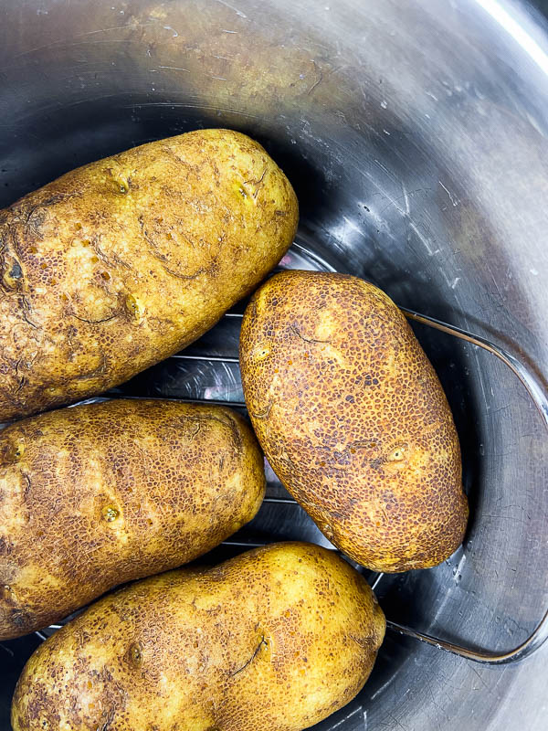 Russet potatoes on a trivet in the Instant pot. 