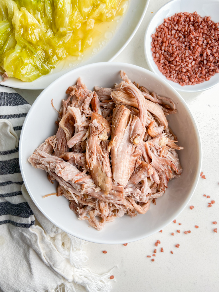 Overhead photo of kalua pork in a white bowl. 