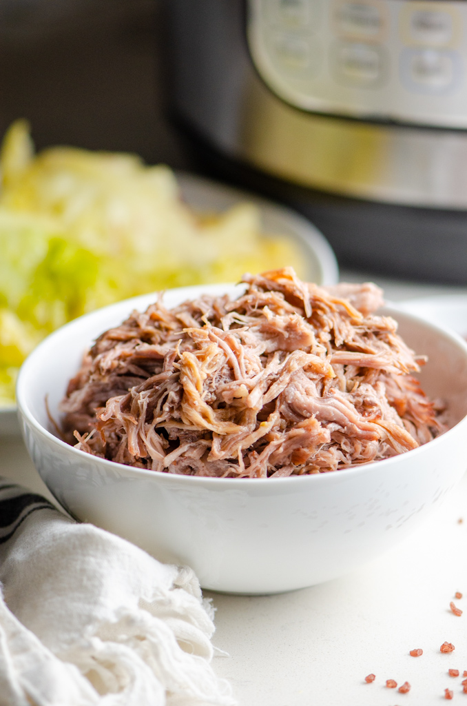 Side photo of instant pot kalua pork in a white bowl. 