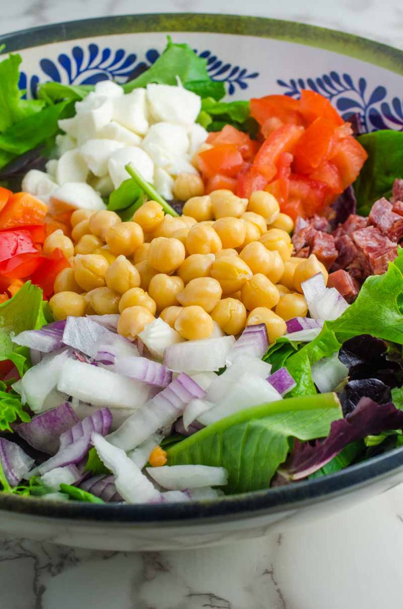 Italian chopped salad LOADED with salami, mozzarella and veggies all tossed in a tangy balsamic dijon vinaigrette.