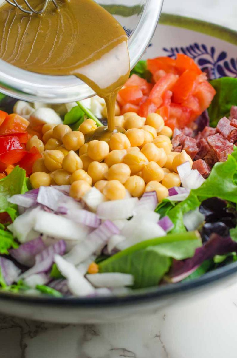 Italian chopped salad LOADED with salami, mozzarella and veggies all tossed in a tangy balsamic dijon vinaigrette.