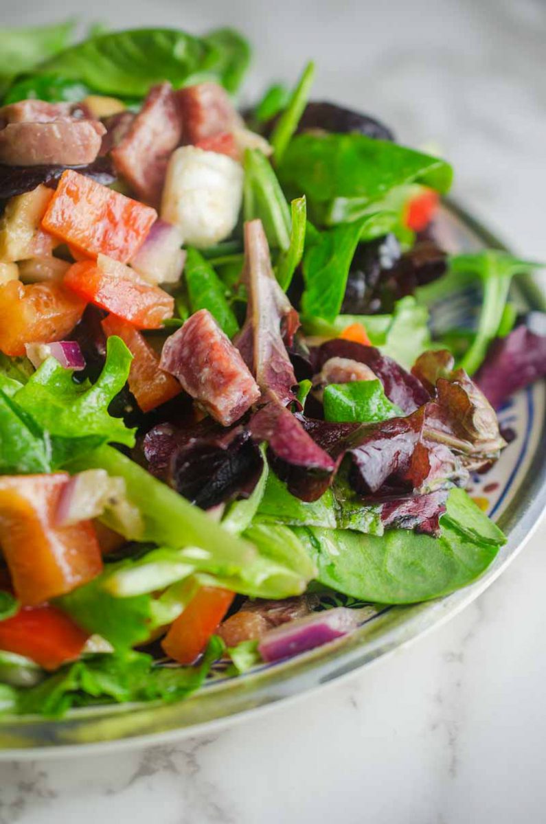 Italian chopped salad LOADED with salami, mozzarella and veggies all tossed in a tangy balsamic dijon vinaigrette.